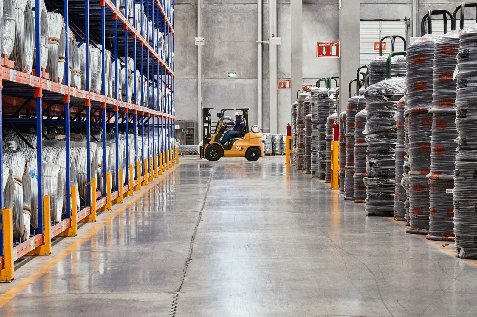 A forklift handling goods inside an industrial warehouse